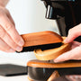 Coffee brush in use to clean around your bean grinder