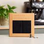 Gift set from Barista Essentials for home baristas, containing black barista cloths and a tamper keyring.